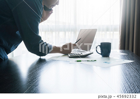 businessman holding phone and work with laptop 45692332