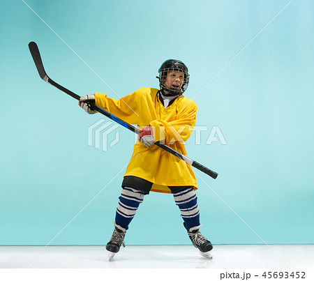 A hockey player with equipment over a blue background 45693452