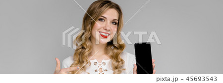 Young woman presenting telephone 45693543