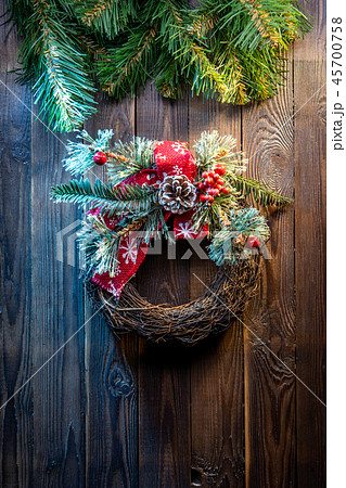Christmas wreath on a rustic wooden door. Christmas wreath on a rustic wooden door. 45700758