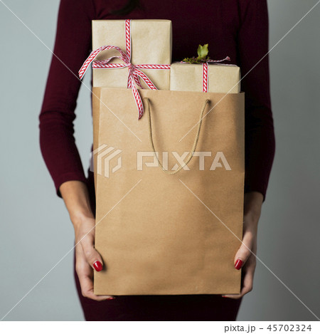 woman with a shopping bag full of gifts woman with a shopping bag full of gifts 45702324