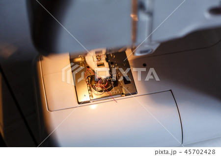 Close-up of a sewing machine with light on 45702428