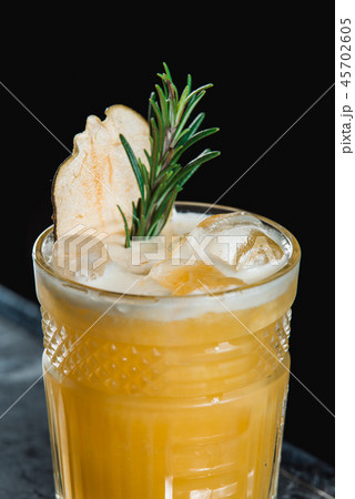 Cold Whiskey Sour Cocktail with ice and apple chips, piece of thyme on top Cold Whiskey Sour Cocktail with ice and apple chips, piece of thyme on top 45702605