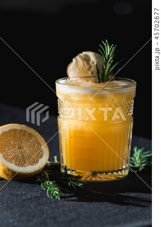 Cold Whiskey Sour Cocktail with ice and apple chips, piece of thyme on top Cold Whiskey Sour Cocktail with ice and apple chips, piece of thyme on top 45702677