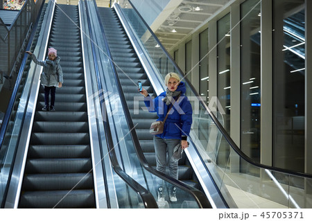 Mother and child together on escalator background. Terminal, airport travel, love care. 45705371