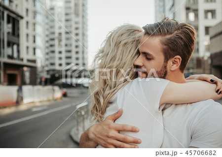 Calm man hugging his girlfriend with blond hair Calm man hugging his girlfriend with blond hair 45706682