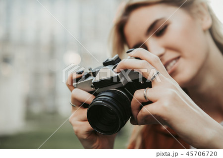 Close up of camera in hands of young woman 45706720