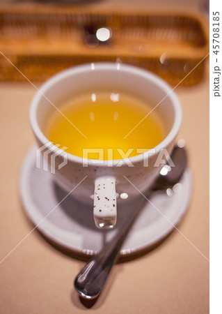 Cup of green tea with spoon in the restaurant 45708185