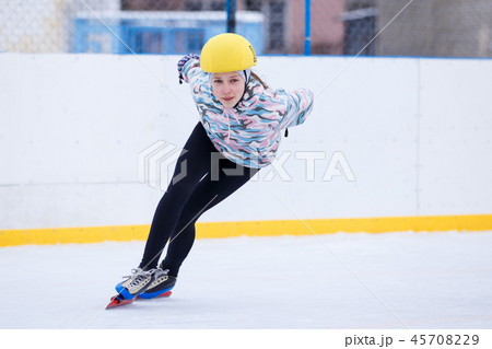 Speed skating young girl on training rink 45708229