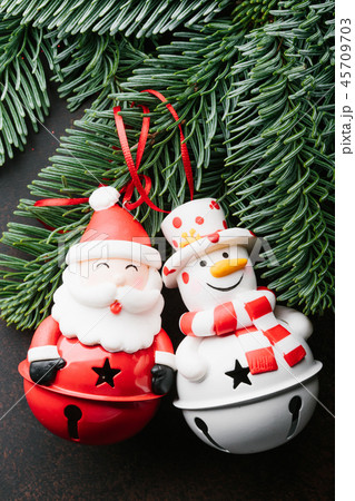 Christmas New Year holiday background. Santa Claus , snowman, and branch tree on dark background Christmas New Year holiday background. Santa Claus , snowman, and branch tree on dark background 45709703