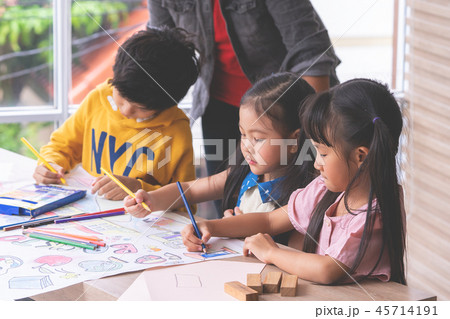 Student kids are painting on paper in Art group Student kids are painting on paper in Art group 45714191