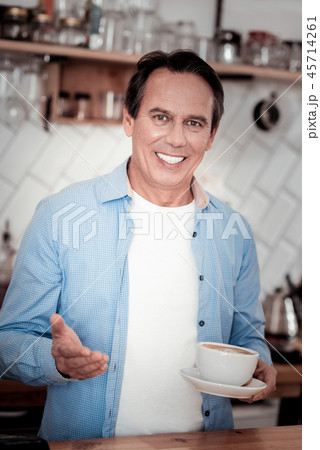Pleasant delighted barista smiling to you Pleasant delighted barista smiling to you 45714261