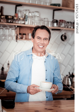 Pleasant nice man standing at the counter Pleasant nice man standing at the counter 45714263