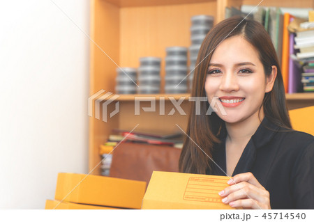 woman managing product delivery for her online woman managing product delivery for her online 45714540