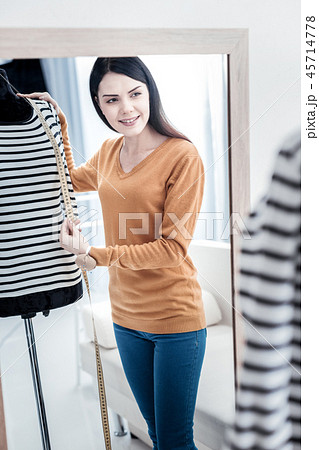 Pleasant skilled woman using a measure tape 45714778