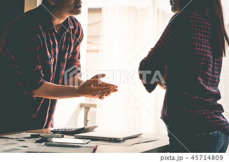 Silhouette co worker is fighting by the windows 45714809