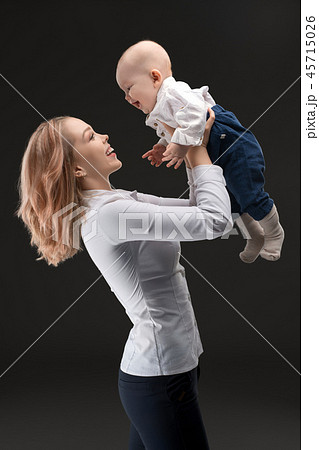 Pretty mother holding her baby profile shot 45715026