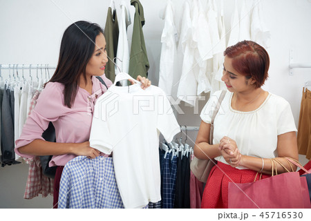 Shop assistant helping customer Shop assistant helping customer 45716530