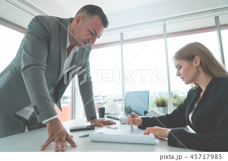 Female showing her boss real estate building plan Female showing her boss real estate building plan 45717985