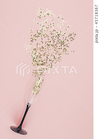 Champagne glass poured out golden stars confetti Champagne glass poured out golden stars confetti 45718367