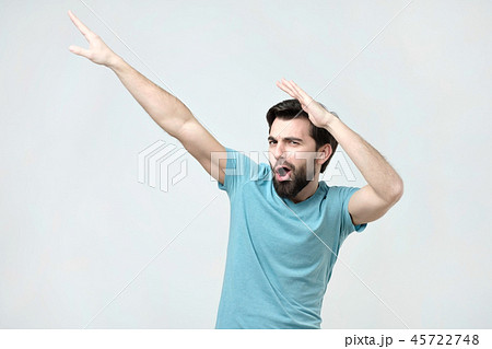 Young happy hispanic man in blue t-shirt dancing. Young happy hispanic man in blue t-shirt dancing. 45722748