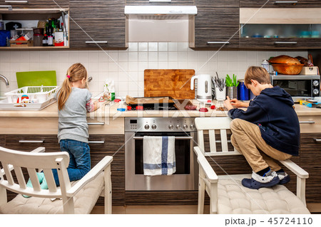 Brother and sister preparing cookies in the kitchen 45724110