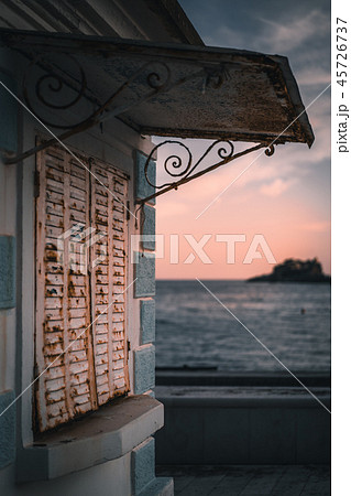 Closed rusty metal shutters of a local cafe 45726737