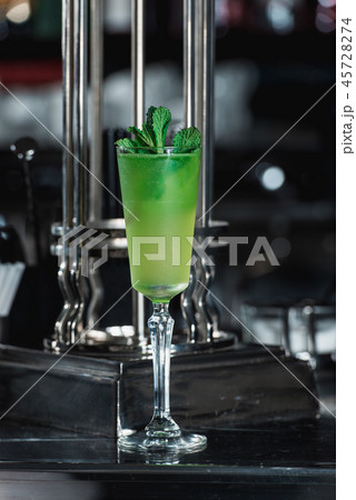 Green refreshing Alcoholic Cocktail. Mint on top Green refreshing Alcoholic Cocktail. Mint on top 45728274