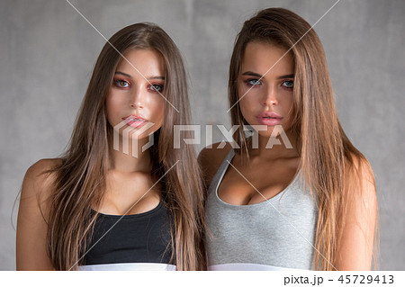 Portrait of a sexy young women in sport underwear on the gray white background. Portrait of a sexy young women in sport underwear on the gray white background. 45729413
