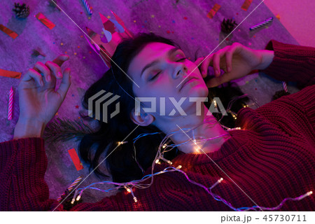 Portrait of young woman with christmas lights on her body. Portrait of young woman with christmas lights on her body. 45730711