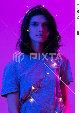 Young woman playing with xmas glowing lights Celebration, Christmas, New Year. 45730714