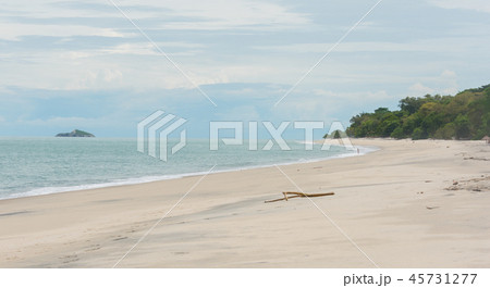 Distant lone girl contemplates braving the water. Distant lone girl contemplates braving the water. 45731277