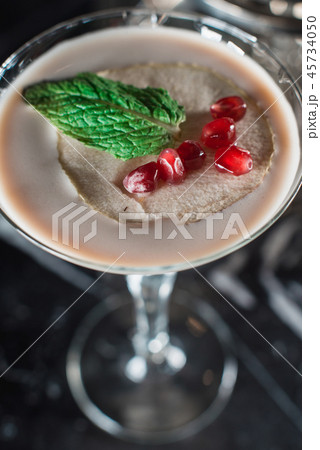 Espresso Martini cocktail, grains of pomegranate on top Espresso Martini cocktail, grains of pomegranate on top 45734050