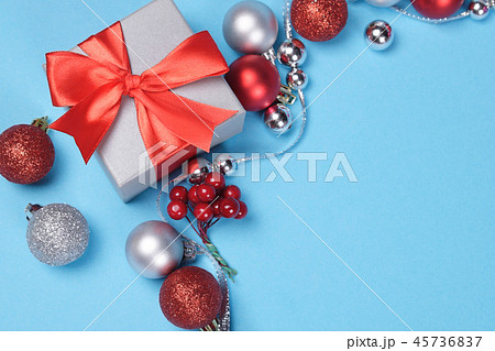 Gift box and red and sliver Christmas baubles. 45736837
