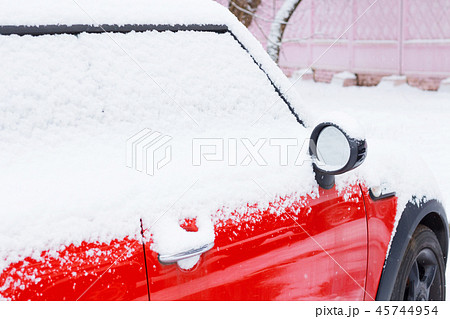 Red car covered after snowfall 45744954