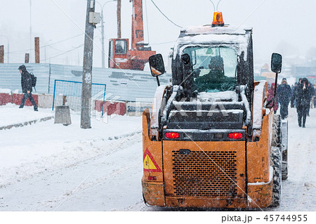 Yellow snowplow removing snow 45744955