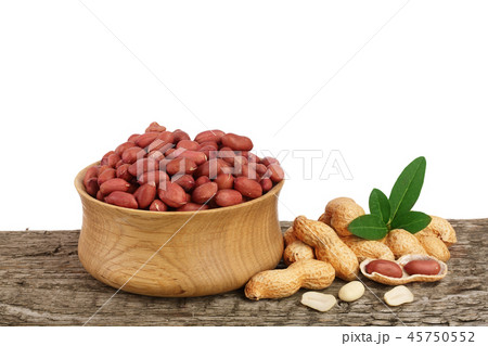 peanuts with leaf in bowl on old wooden background peanuts with leaf in bowl on old wooden background 45750552