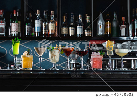 row of various colourfull alcoholic cocktails on a bar desk. Glasses of differen shapes 45750903
