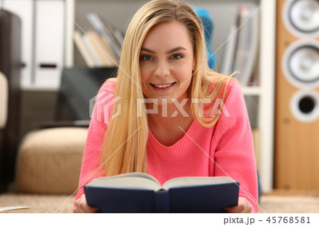 young beautiful blond woman lie on the floor read book young beautiful blond woman lie on the floor read book 45768581