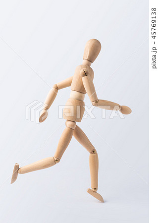 running wooden mannequin isolated on white 45769138