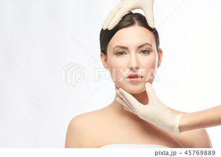 Plastic medical consultation. Doctor hands. Woman Plastic medical consultation. Doctor hands. Woman 45769889