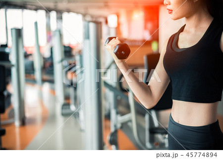 Hand of sports woman lifting dumbbell Hand of sports woman lifting dumbbell 45774894