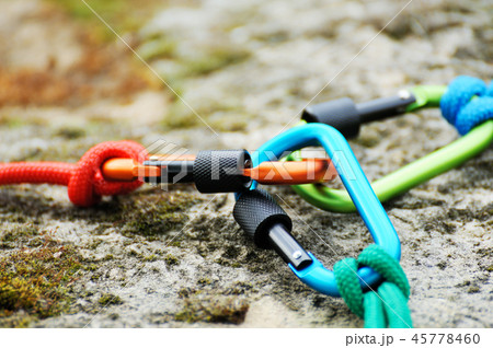 Carabiner  on rocky background. Carabiner  on rocky background. 45778460