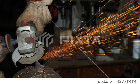 Angle grinder cutting steel with sparks Angle grinder cutting steel with sparks 45778484