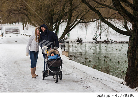 Happy young family walking in the park in winter Happy young family walking in the park in winter 45779396