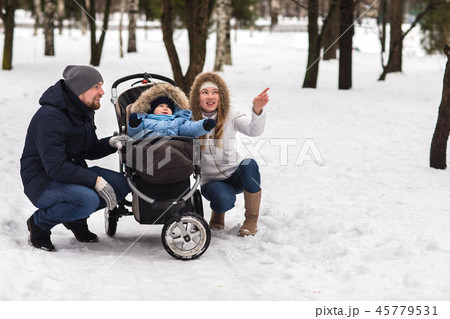 Happy young family walking in the park in winter Happy young family walking in the park in winter 45779531