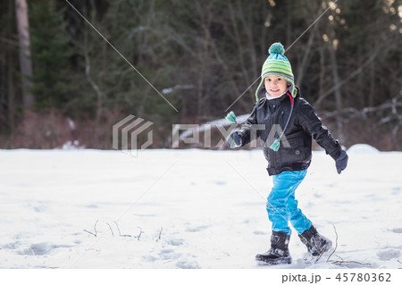 Handsome young boy in the winter forest. 45780362