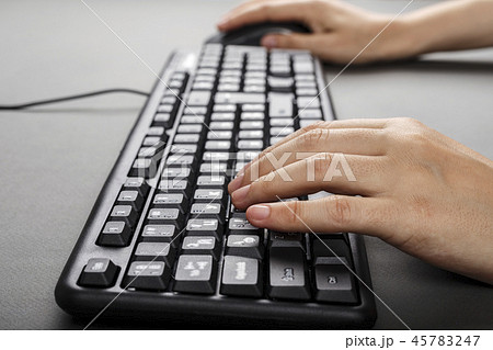 hands on a computer keyboard 45783247