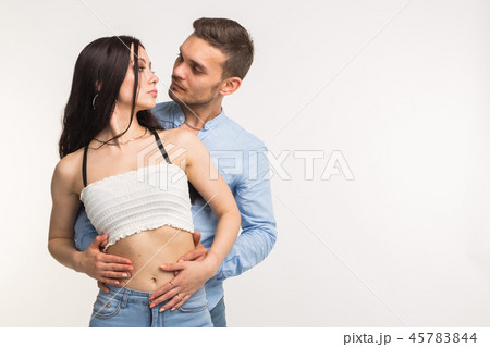 Young man hugging his girlfriend on white background with copy space Young man hugging his girlfriend on white background with copy space 45783844