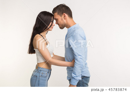 Relationship problems concept - Angry young woman hugging her husband on white background 45783874